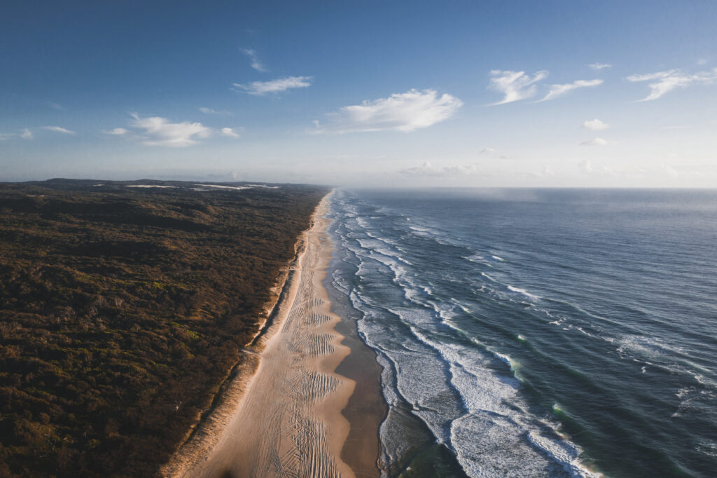 Drone view of a Cape Cod coastline under a blue sky