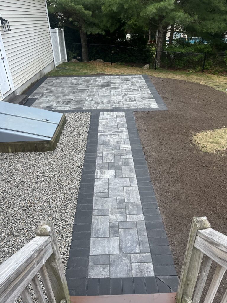 New paver walkway leading from deck to backyard patio